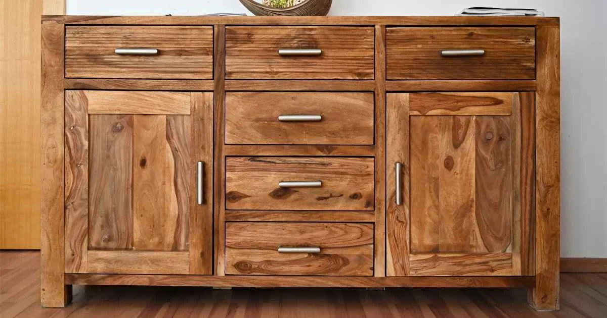 Solid wood cabinet with drawers and doors on a hardwood floor.
